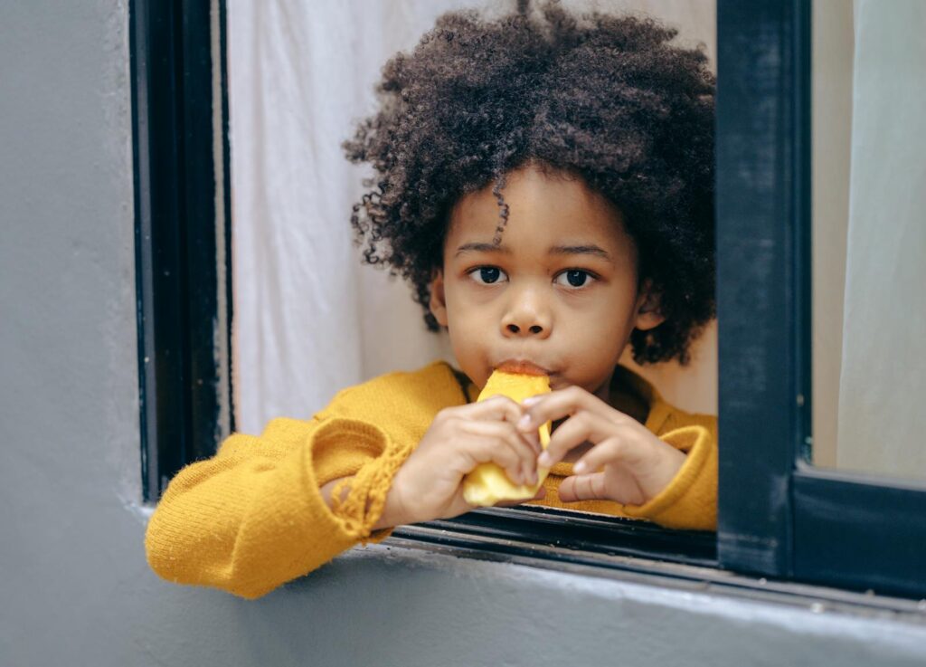 Content black boy enjoying exotic fruit